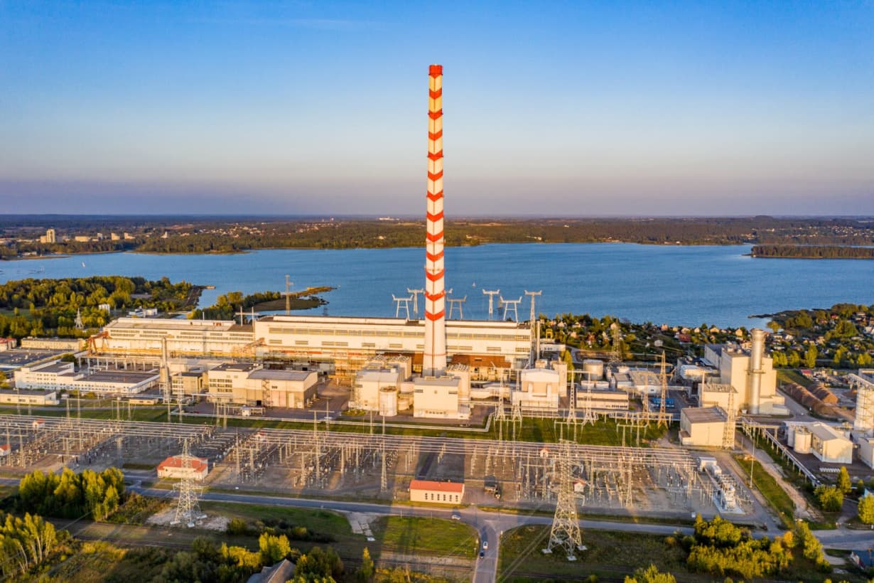 Massive cooling towers of Elektrėnai power plant rising above the flat Lithuanian landscape