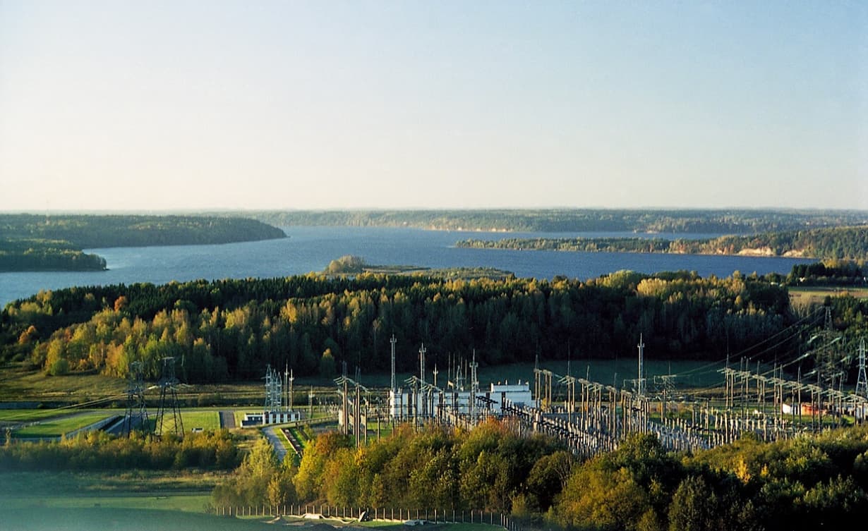 Sandy beach on the shore of the Kaunas Reservoir with distant forested hills