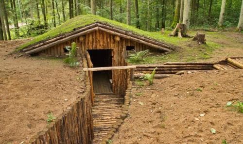 Hidden entrance to a reconstructed Lithuanian partisan bunker in the forest