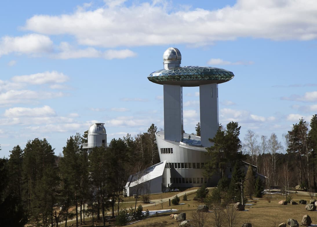 Futuristic glass building of the Museum of Ethnocosmology at dusk
