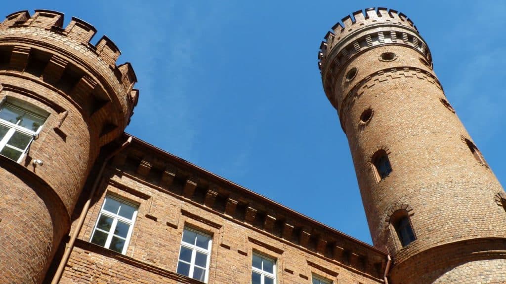 Red-brick Raudonė Castle tower rising above the Nemunas River valley