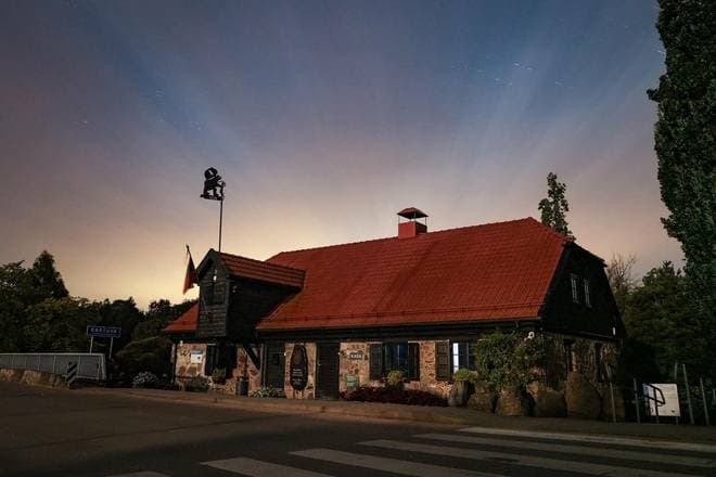 Collection of carved and fossil-bearing glacial boulders at Mosėdis rock museum